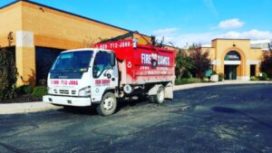 Fire Dawgs truck performing Commercial Junk Removal